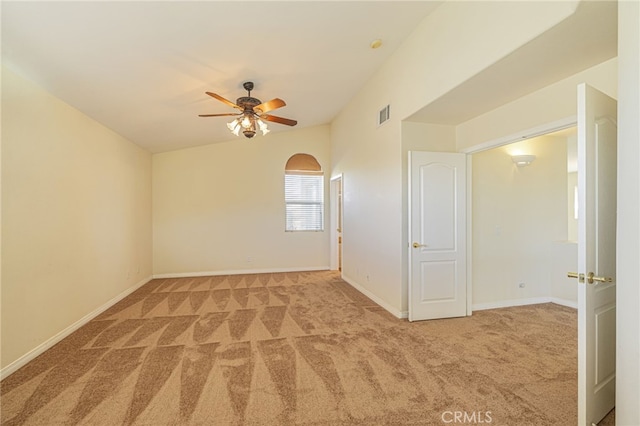 carpeted empty room with ceiling fan, visible vents, and baseboards