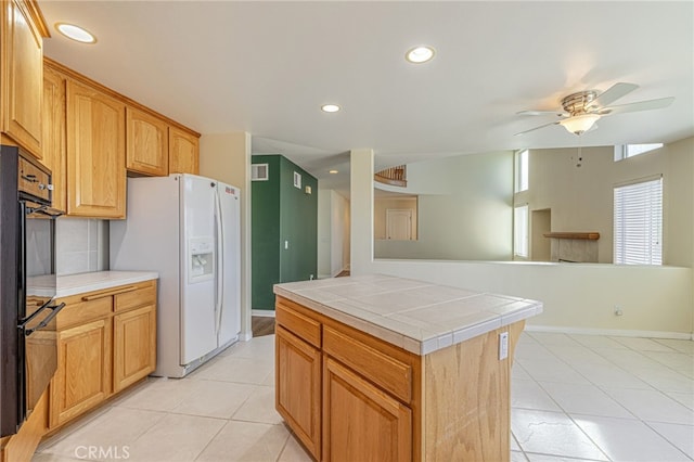 41445 Terrazzo Dr, Palmdale, CA 93551 - kitchen featuring white refrigerator with ice dispenser, tile countertops, a ceiling fan, light tile patterned floors, and recessed lighting