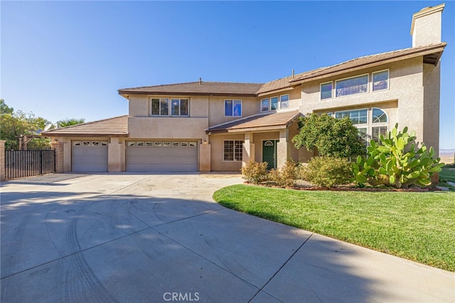 view of front of home featuring driveway, stucco siding, a chimney, fence, and a front yard