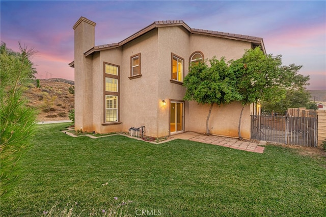 41445 Terrazzo Dr, Palmdale, CA 93551 - back of property featuring a chimney, stucco siding, and a patio