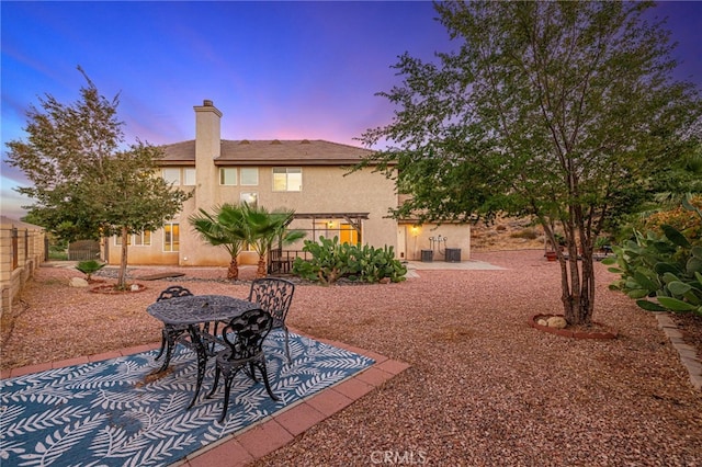 41445 Terrazzo Dr, Palmdale, CA 93551 - yard at dusk with a patio, a fenced backyard, and cooling unit