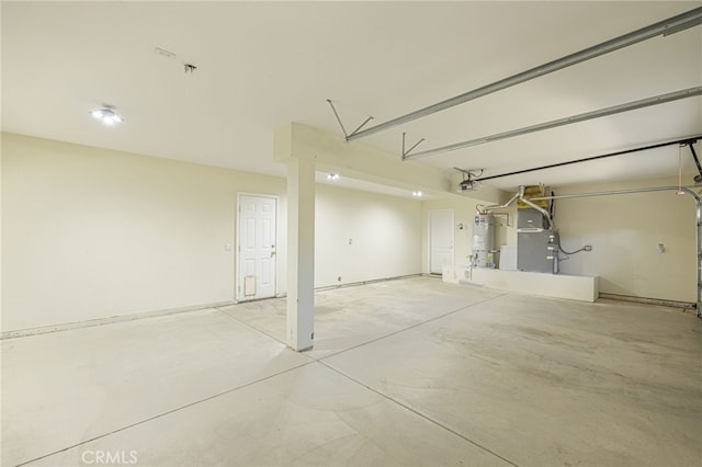 garage featuring strapped water heater and heating unit