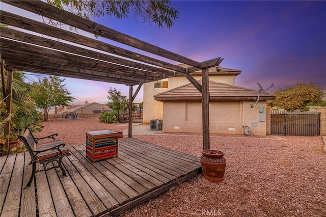 41445 Terrazzo Dr, Palmdale, CA 93551 - deck at dusk with a pergola, central AC unit, and a gate