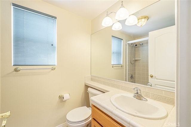 bathroom with a shower, vanity, and toilet