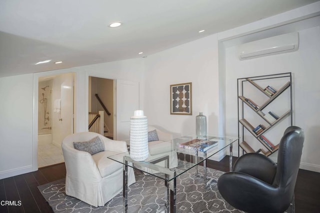 living area with recessed lighting, lofted ceiling, an AC wall unit, wood finished floors, and baseboards