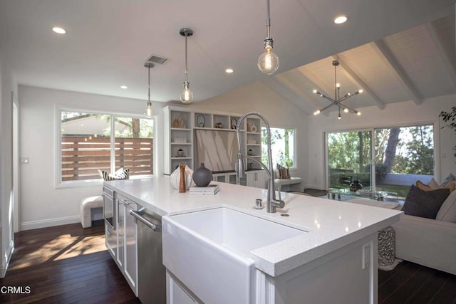 kitchen with vaulted ceiling, dark wood finished floors, open floor plan, and a sink