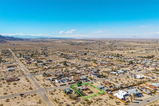 drone / aerial view featuring view of desert and a mountain view