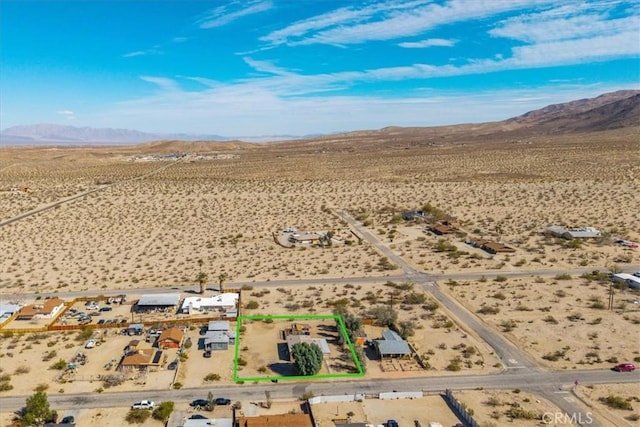 birds eye view of property with a rural view, a mountain view, and view of desert