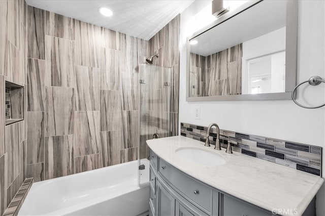 full bathroom with backsplash, vanity, and washtub / shower combination