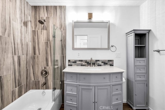 bathroom featuring shower / bathtub combination, tasteful backsplash, and vanity