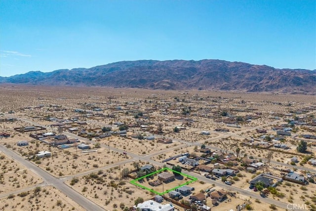 birds eye view of property featuring a desert view, a rural view, and a mountain view