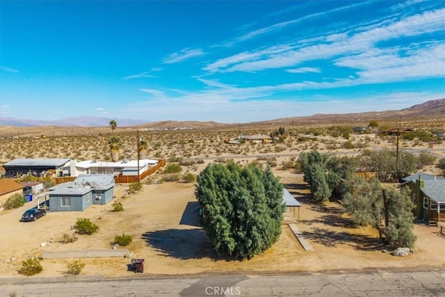 drone / aerial view with view of desert, a rural view, and a mountain view