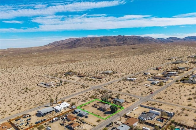 aerial view featuring a desert view and a mountain view