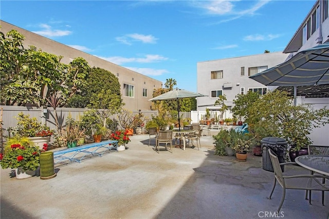 view of patio with fence and outdoor dining area