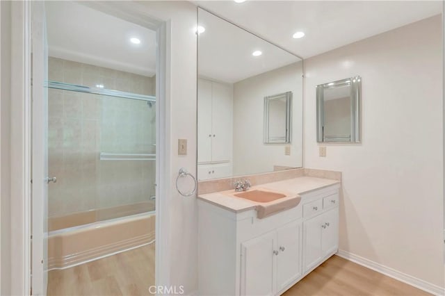 bathroom featuring recessed lighting, tub / shower combination, vanity, and wood finished floors