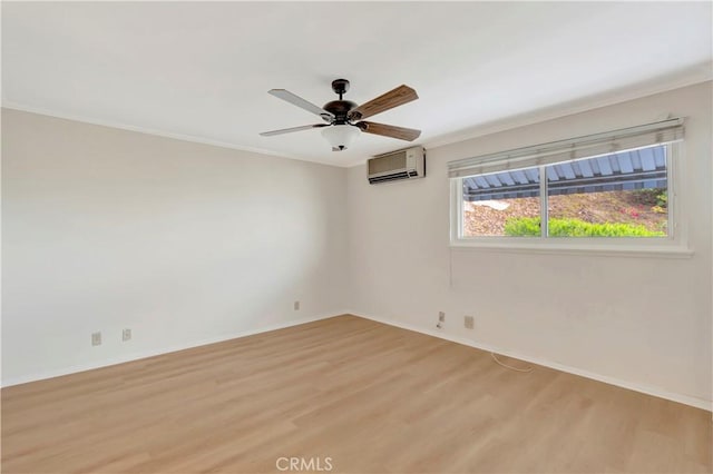 unfurnished room with ceiling fan, light wood finished floors, a wall unit AC, and baseboards