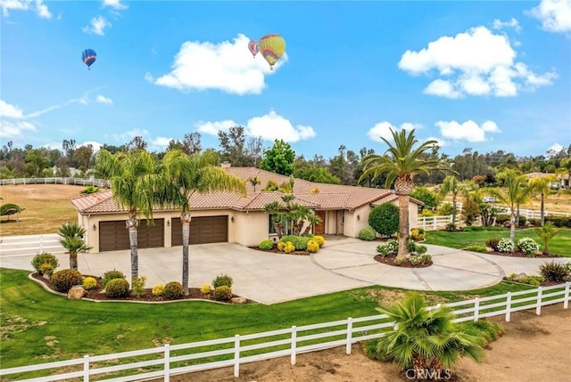 view of front of house with a fenced front yard, concrete driveway, and a front yard