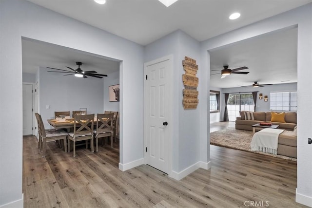 dining room featuring light wood-type flooring, baseboards, and recessed lighting