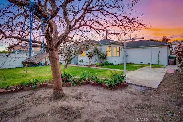 yard at dusk with a patio