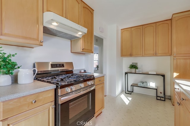 kitchen featuring stainless steel gas stove, under cabinet range hood, and light brown cabinets