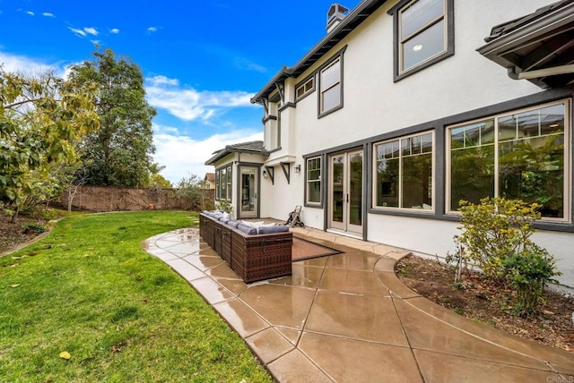 view of yard with an outdoor hangout area, french doors, a patio area, and fence