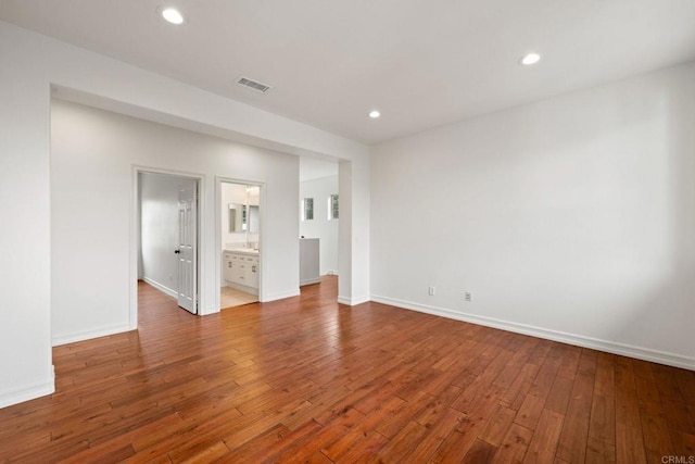 unfurnished bedroom with baseboards, hardwood / wood-style floors, visible vents, and recessed lighting