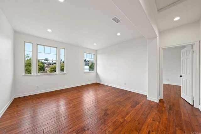 unfurnished room with hardwood / wood-style floors, recessed lighting, and baseboards