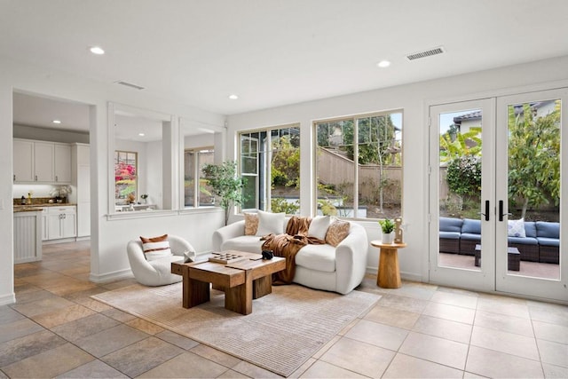 sunroom featuring french doors and visible vents