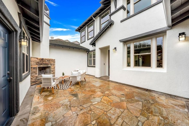 view of patio with an outdoor stone fireplace