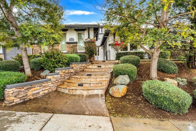 view of front of home with stone siding and stucco siding