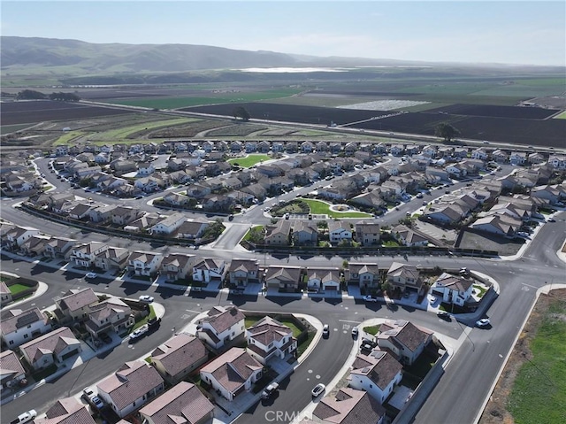 birds eye view of property with a mountain view and a residential view