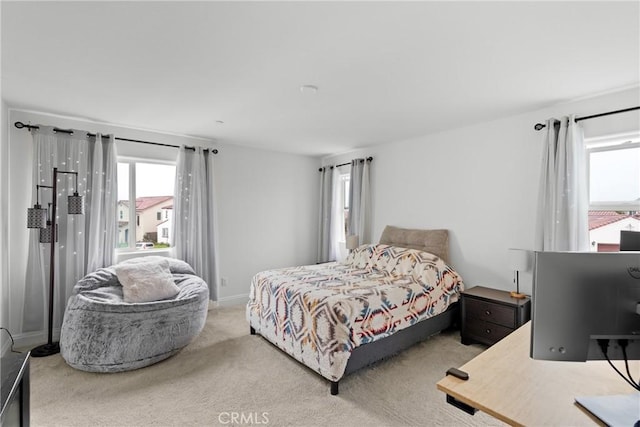 bedroom featuring baseboards, multiple windows, and carpet flooring