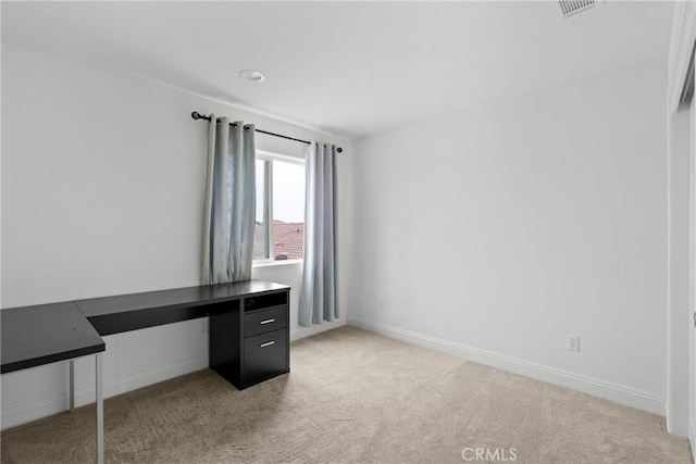 unfurnished office featuring light carpet, visible vents, and baseboards