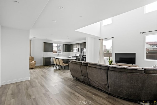 living area with light wood-style floors and baseboards