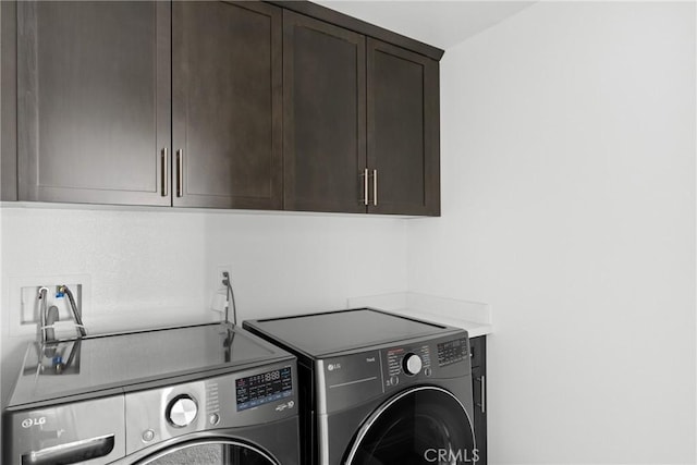 laundry area with cabinet space and independent washer and dryer