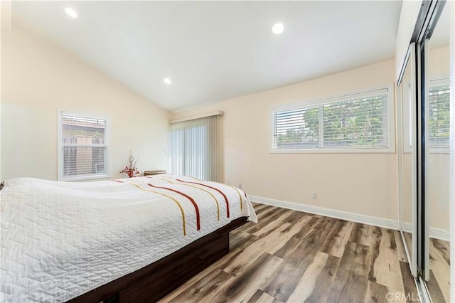 bedroom with baseboards, vaulted ceiling, recessed lighting, and wood finished floors