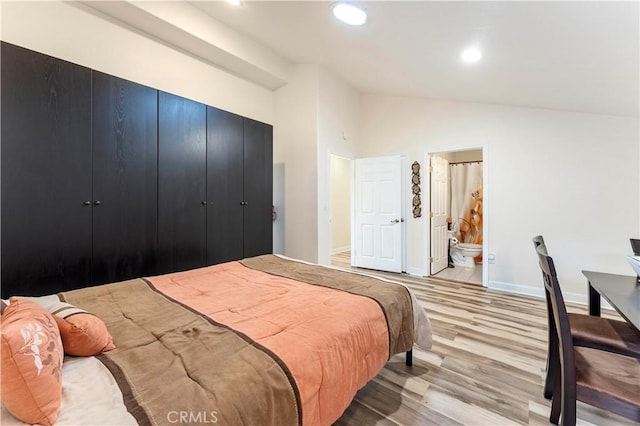 bedroom with lofted ceiling, a closet, recessed lighting, light wood-type flooring, and baseboards