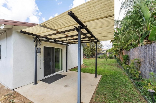 view of patio / terrace with a pergola and fence