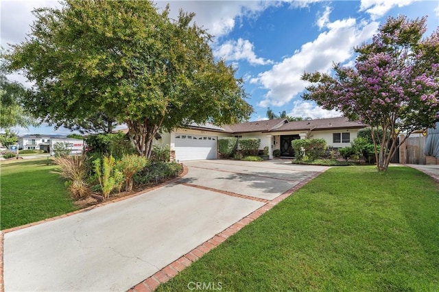 single story home featuring a garage, a front yard, driveway, and stucco siding