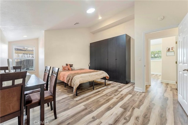 bedroom featuring light wood-style flooring, multiple windows, vaulted ceiling, and recessed lighting