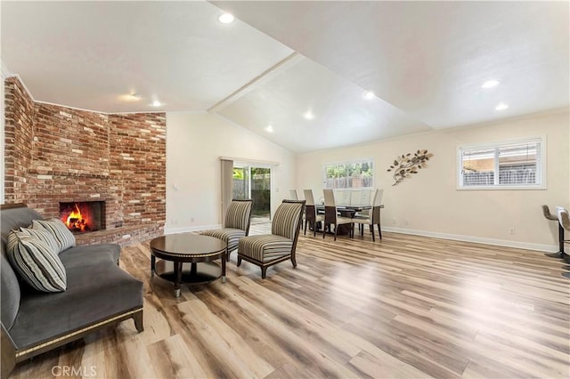 sitting room featuring lofted ceiling, recessed lighting, a fireplace, baseboards, and light wood finished floors