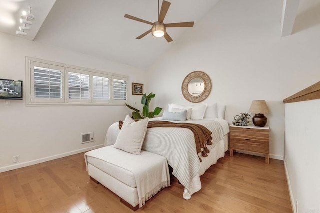 bedroom with visible vents, light wood-style floors, ceiling fan, high vaulted ceiling, and baseboards