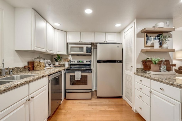 kitchen featuring recessed lighting, stainless steel appliances, white cabinets, light wood-type flooring, and open shelves