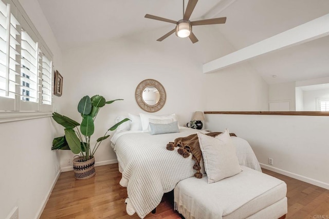 bedroom with lofted ceiling, ceiling fan, baseboards, and wood finished floors