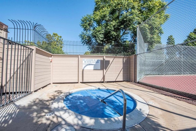 view of pool featuring fence