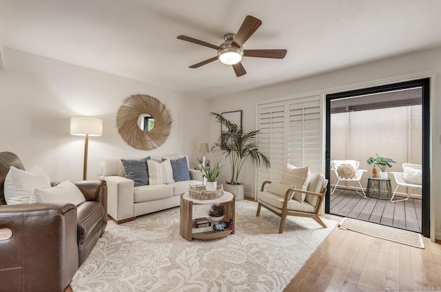 living room featuring ceiling fan and wood finished floors