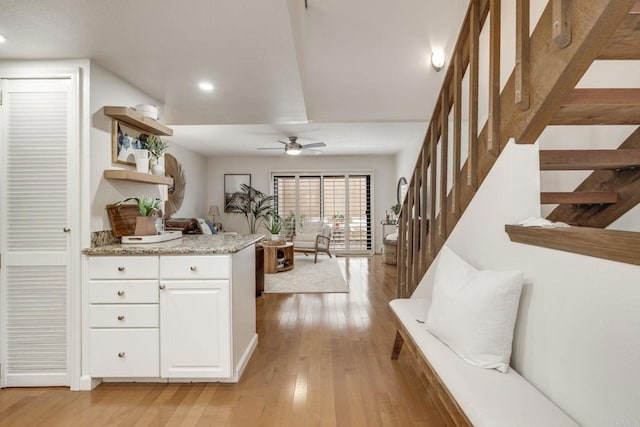 interior space with light wood-type flooring, a ceiling fan, and recessed lighting