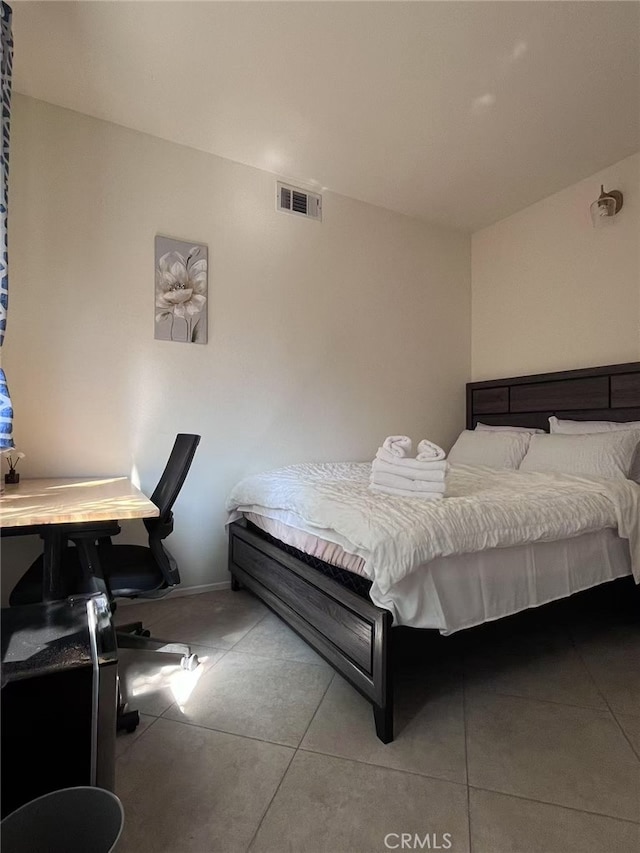 bedroom with tile patterned flooring and visible vents