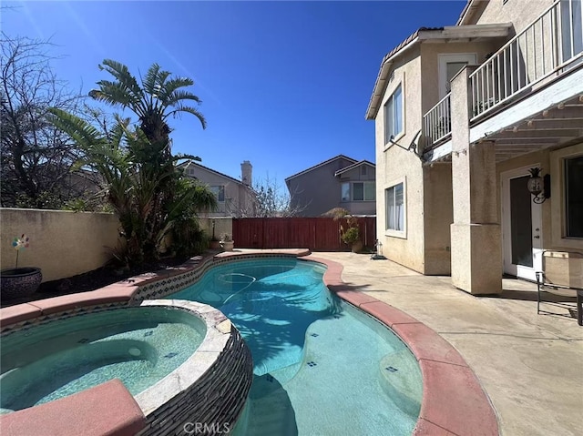 view of pool with a patio area, a fenced backyard, and a pool with connected hot tub