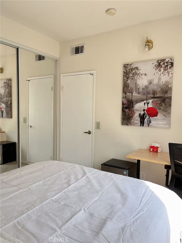 bedroom featuring a closet and visible vents